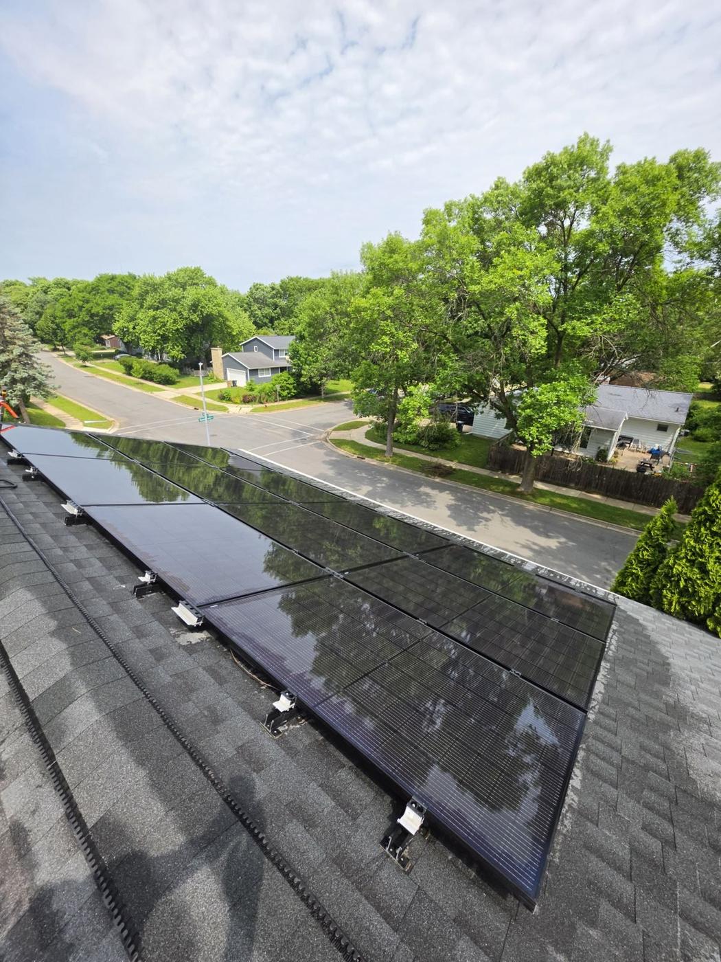 Residential solar panels after Solar Alchemist cleaning — sky reflecting clearly