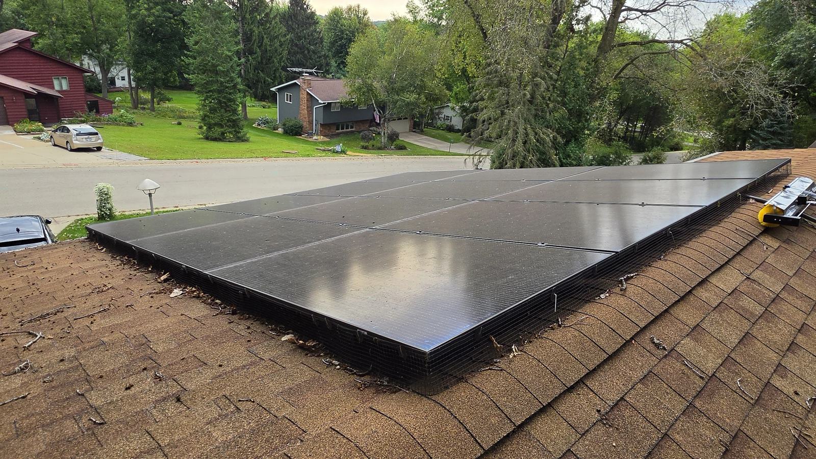 Waunakee rooftop solar array with a film of grime across the panels, before cleaning